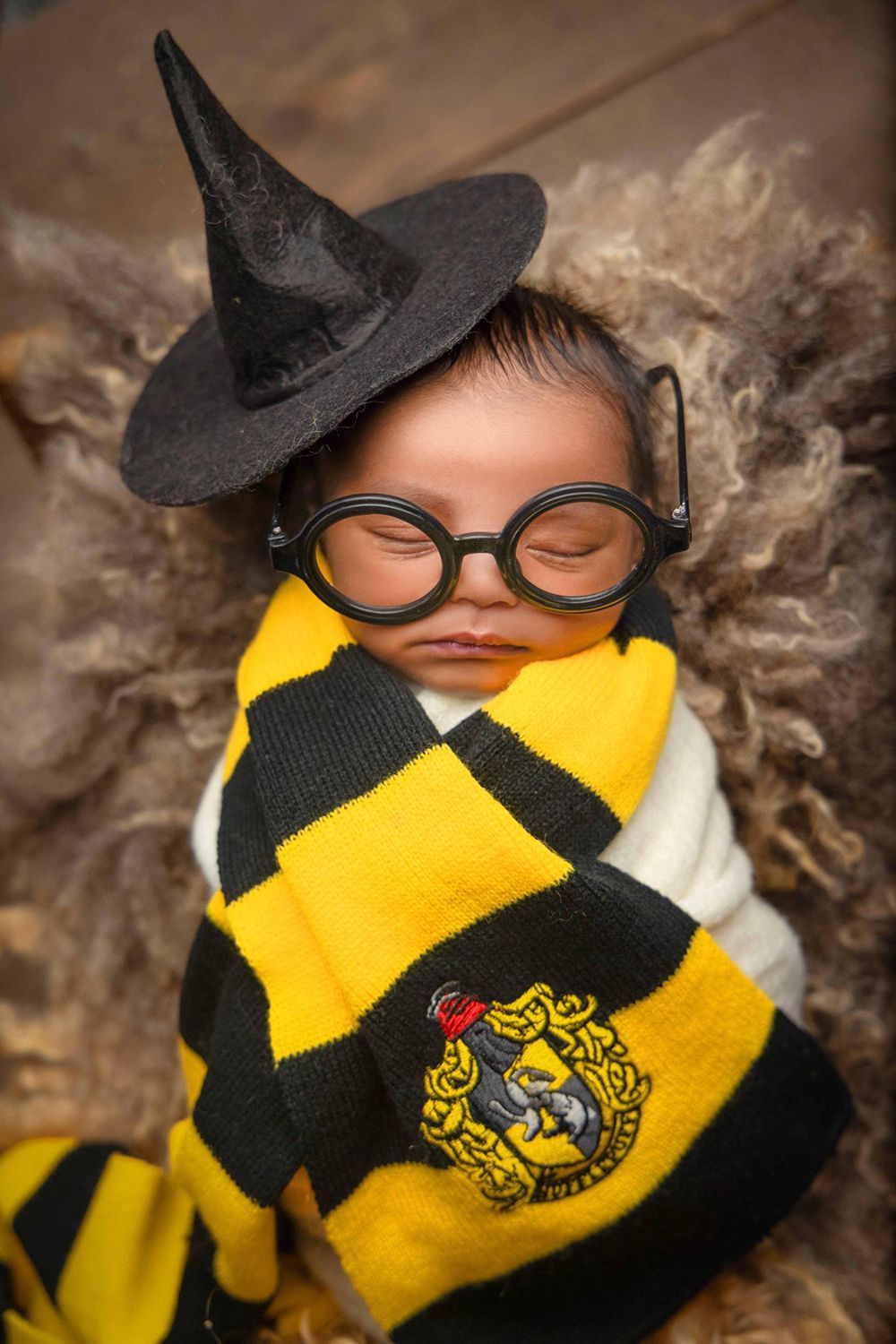 Newborn wearing a Hufflepuff scarf