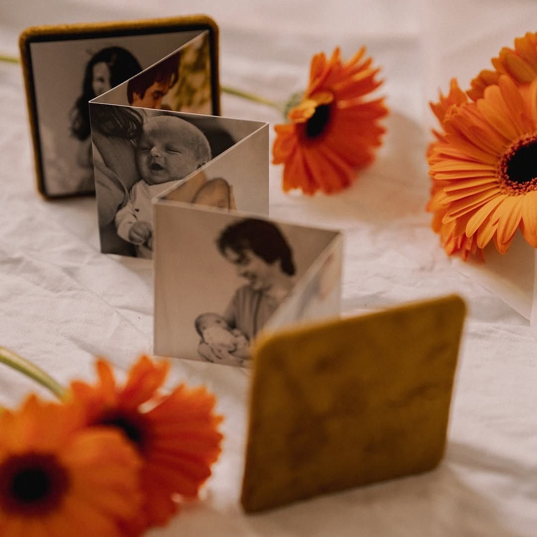 A bunch of pictures on a table with flowers