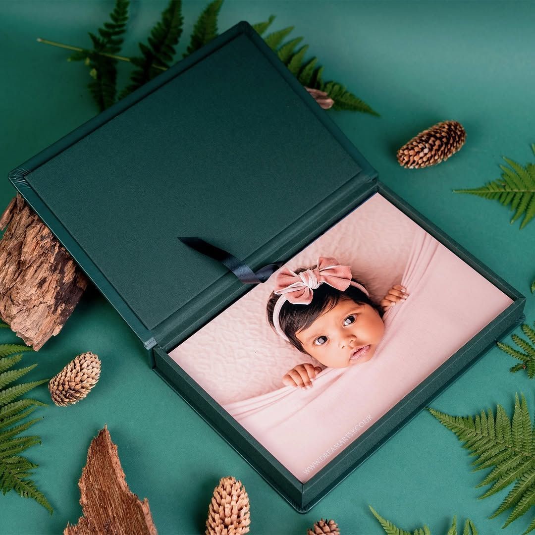 A green box with a picture of a baby in it