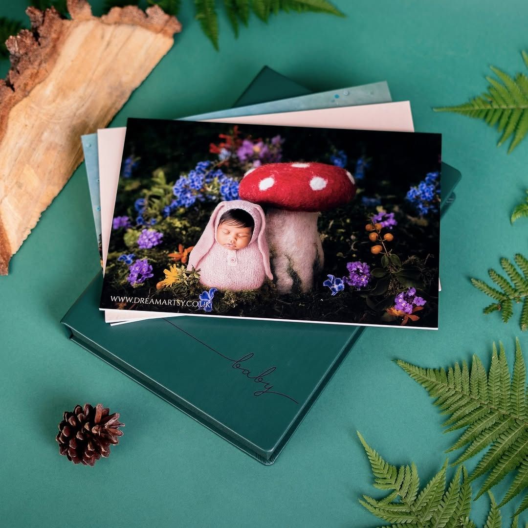 A picture of a baby sitting under a mushroom