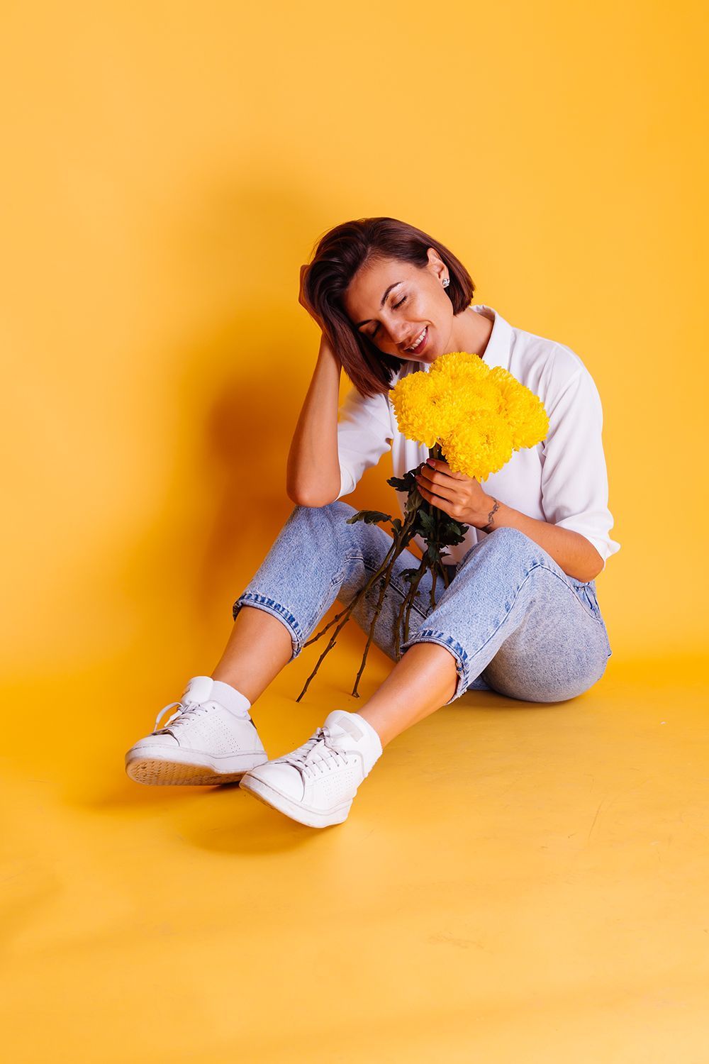 Girl holding yellow flowers