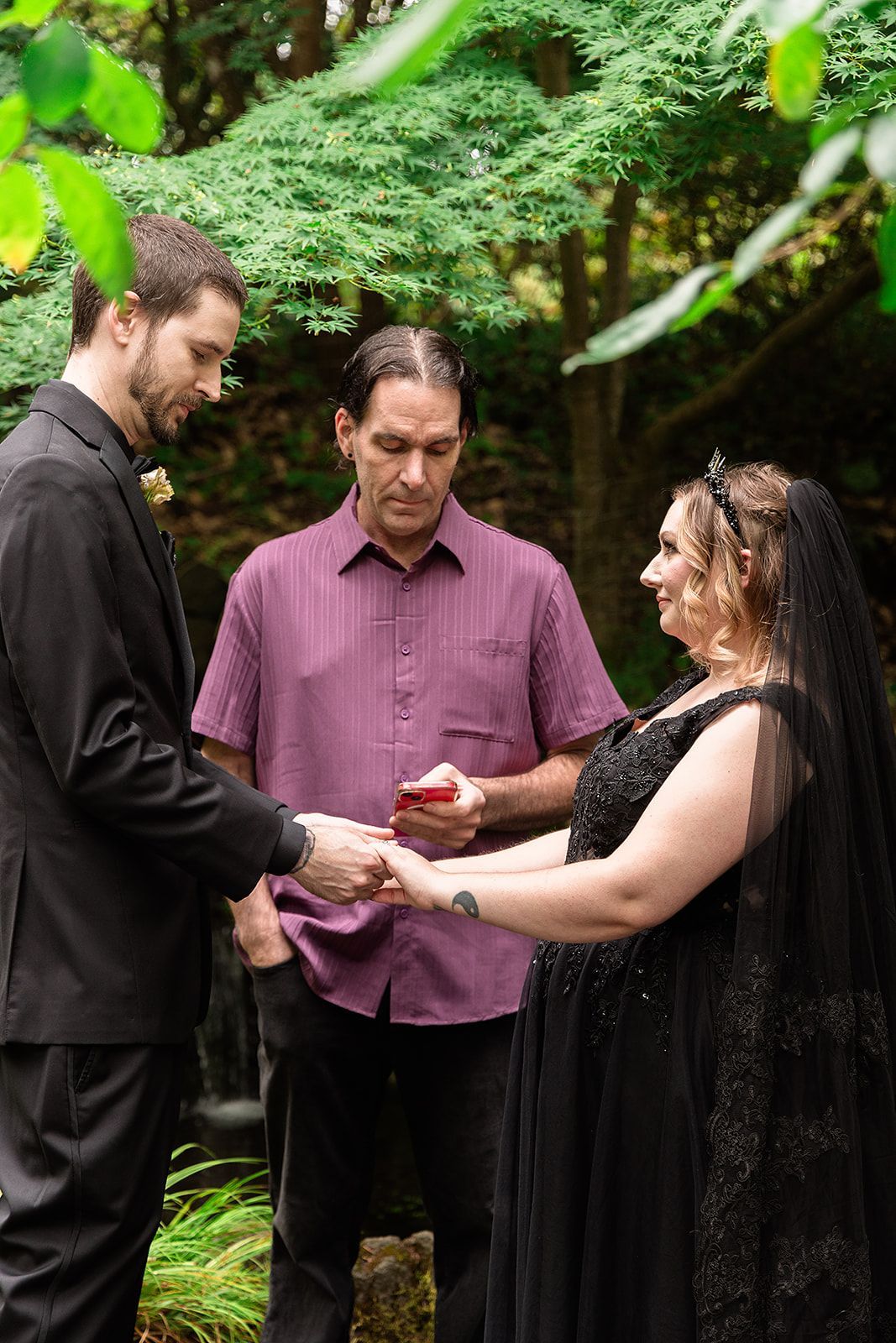 A bride and groom are holding hands during their wedding ceremony.