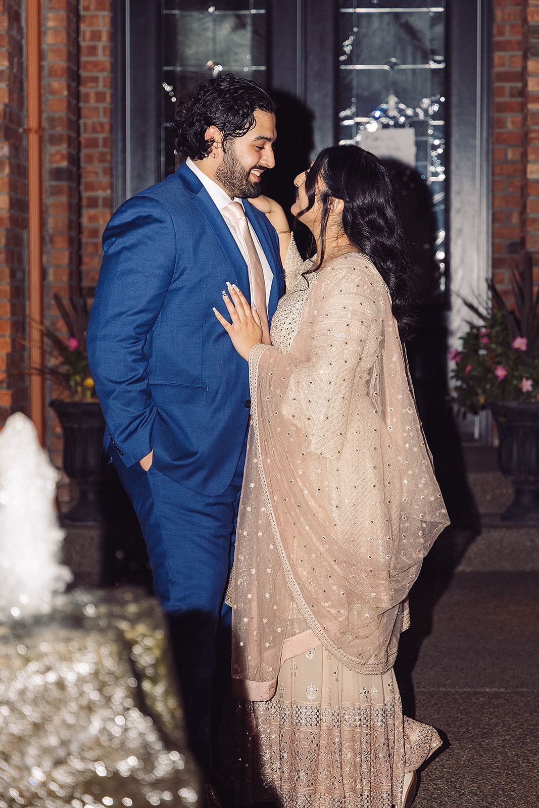 A bride and groom are posing for a picture