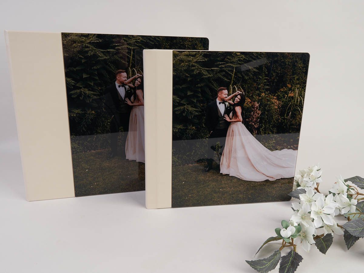 Two wedding albums with a bride and groom on them