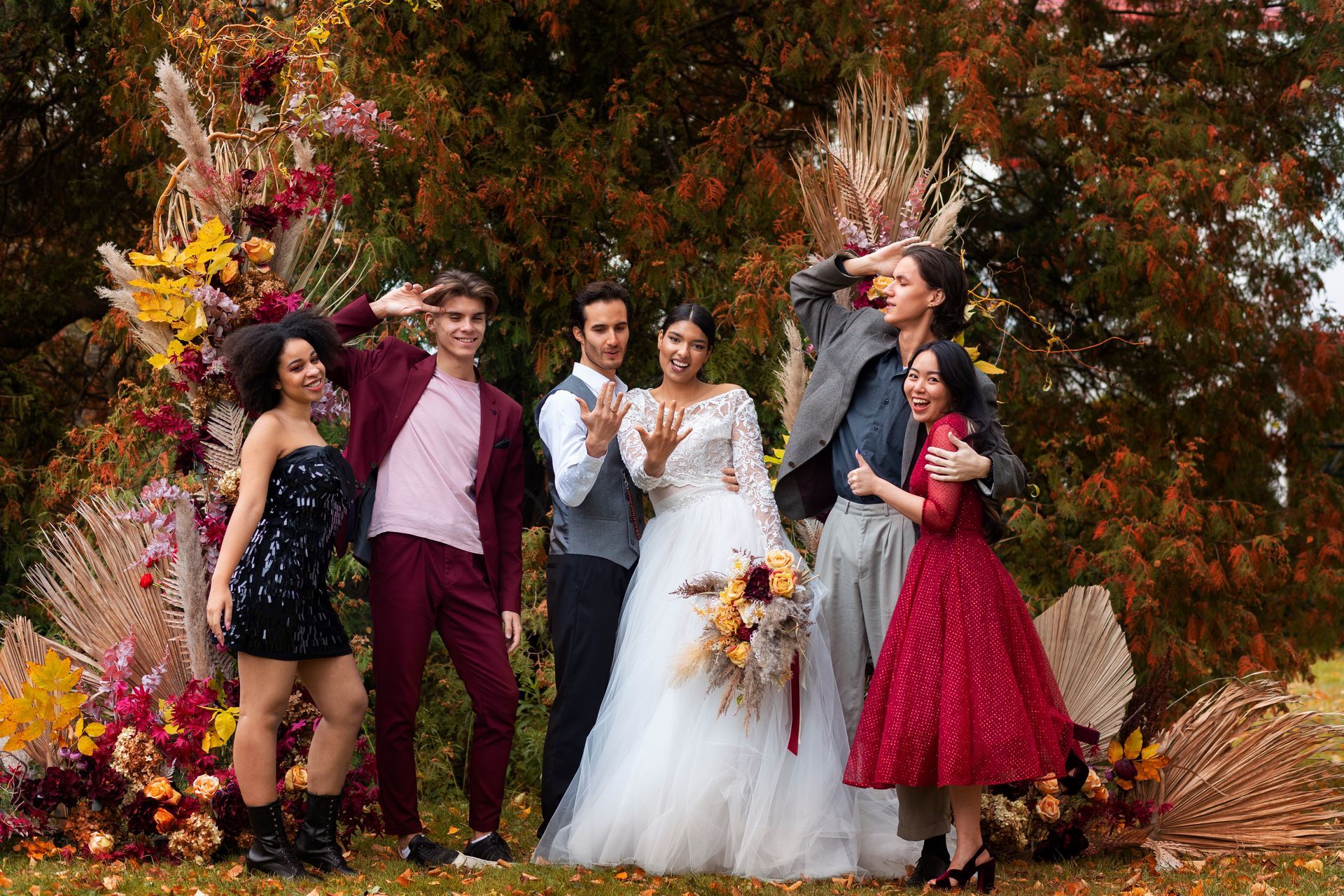 A group of people posing for a picture with a bride and groom