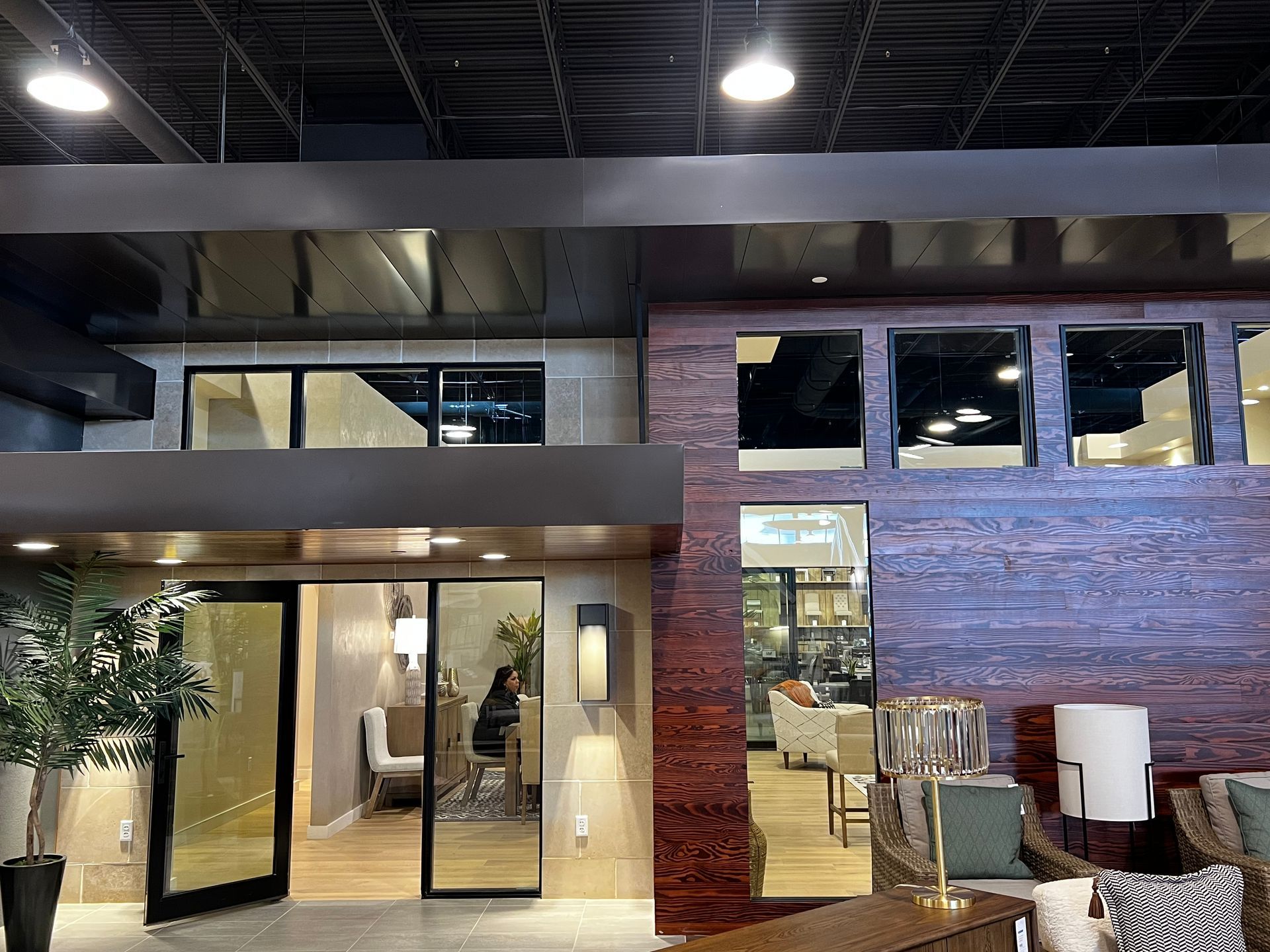 Modern interior with glass doors, windows, and textured wall accents.