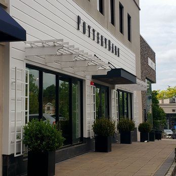 stone steps leading up to a large multi-story house with a grey roof
