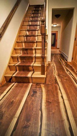 Wooden stairs and floor with natural edges in a hallway.