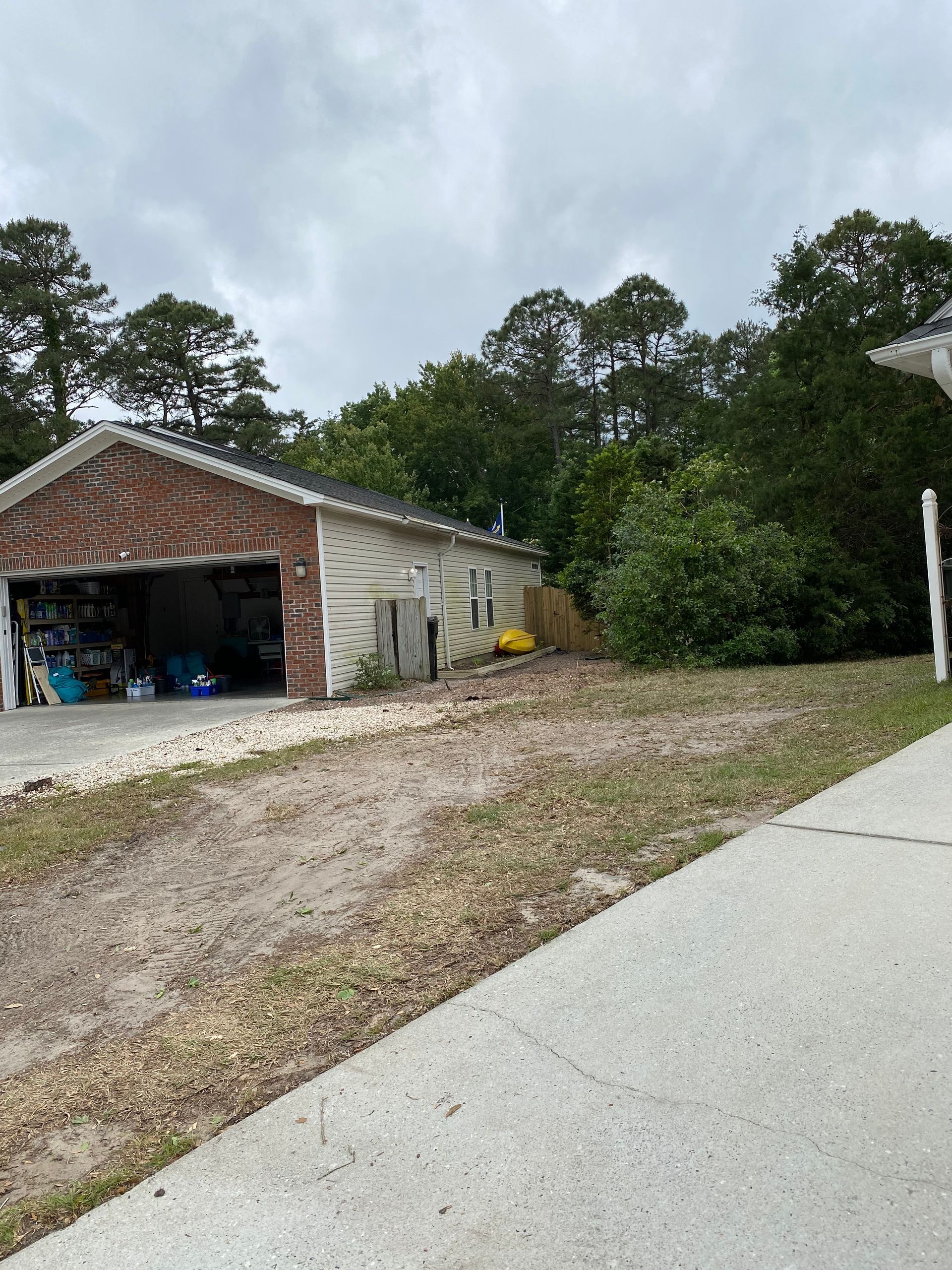 A house with a garage and a driveway in front of it.