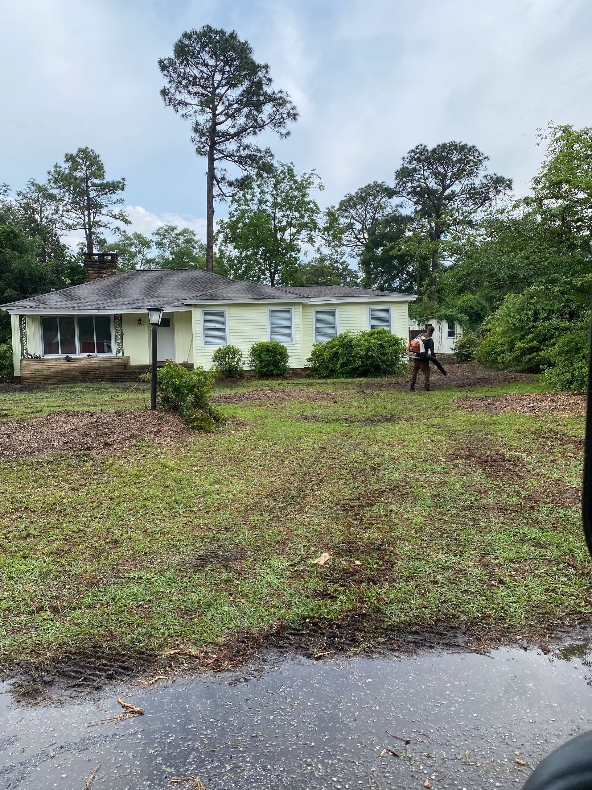 A couple of people are walking in front of a house.