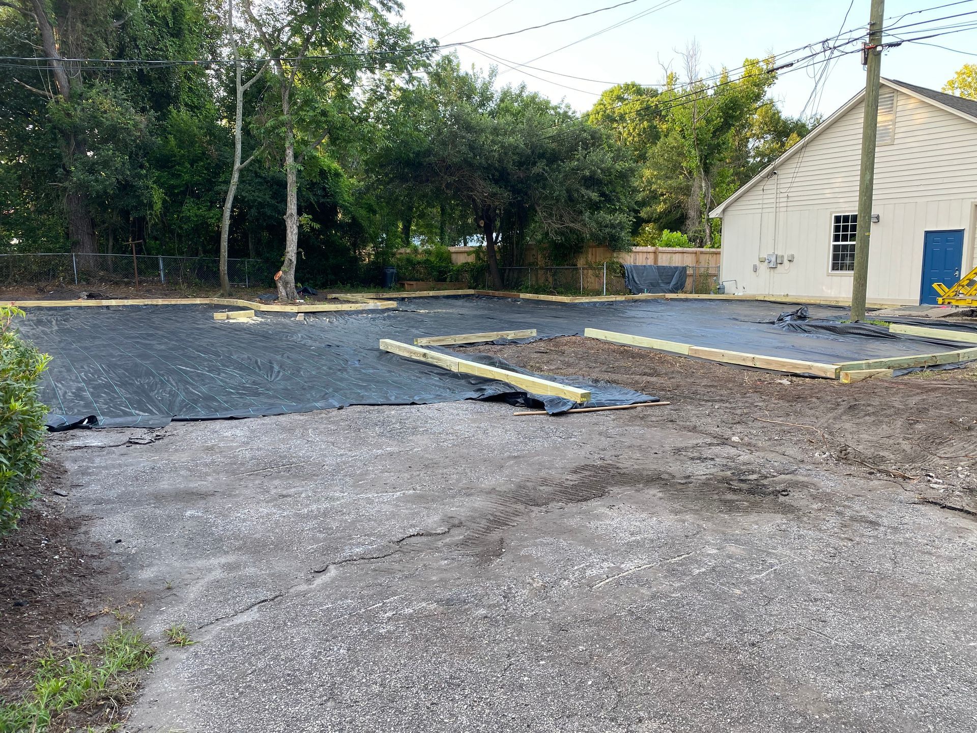 A parking lot is being built next to a house.