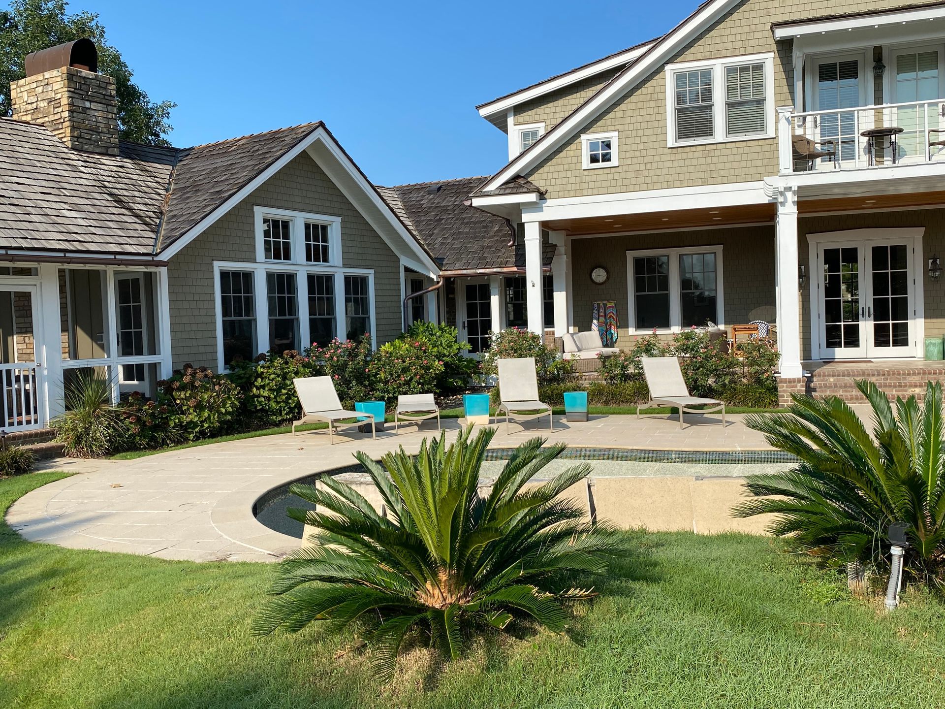 A large house with a swimming pool in front of it.