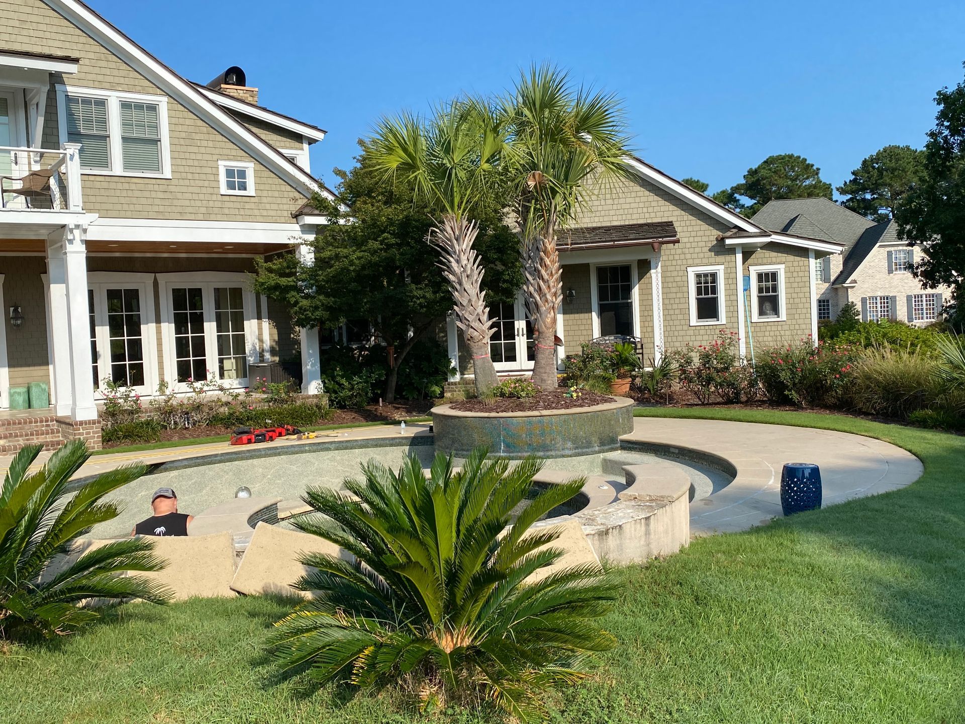 A large house with a swimming pool in front of it.