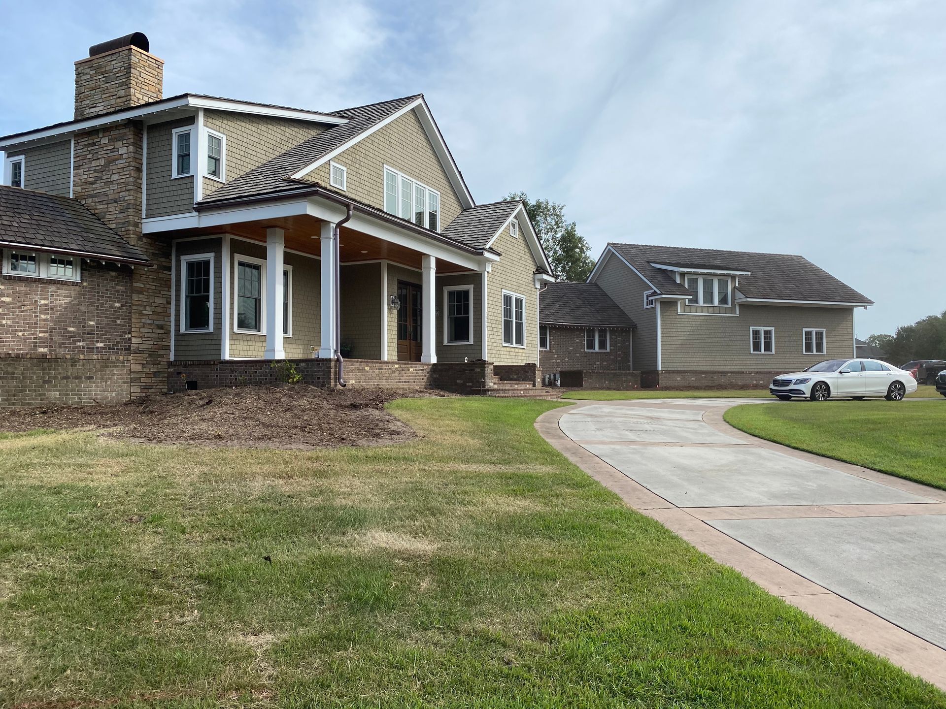 A large house with a car parked in front of it.