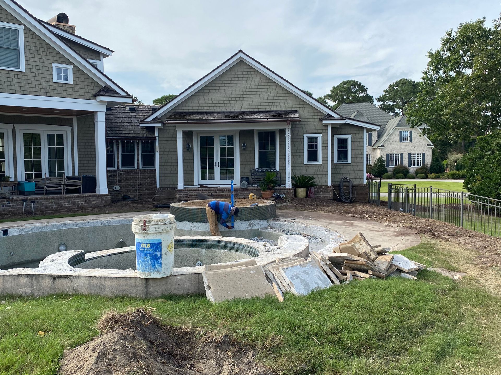 A house is being built with a pool in the backyard.