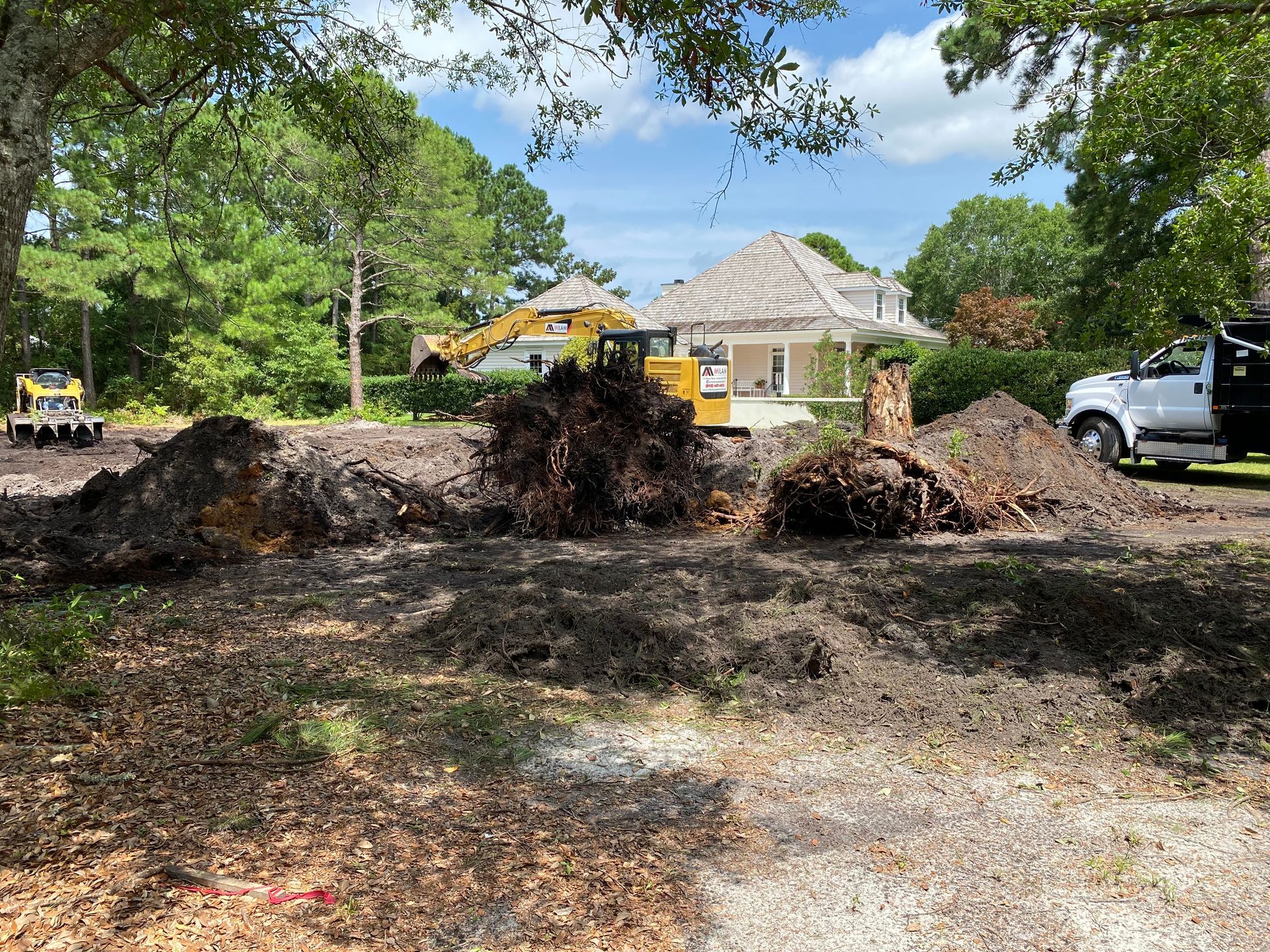 A large pile of dirt is sitting in front of a house.