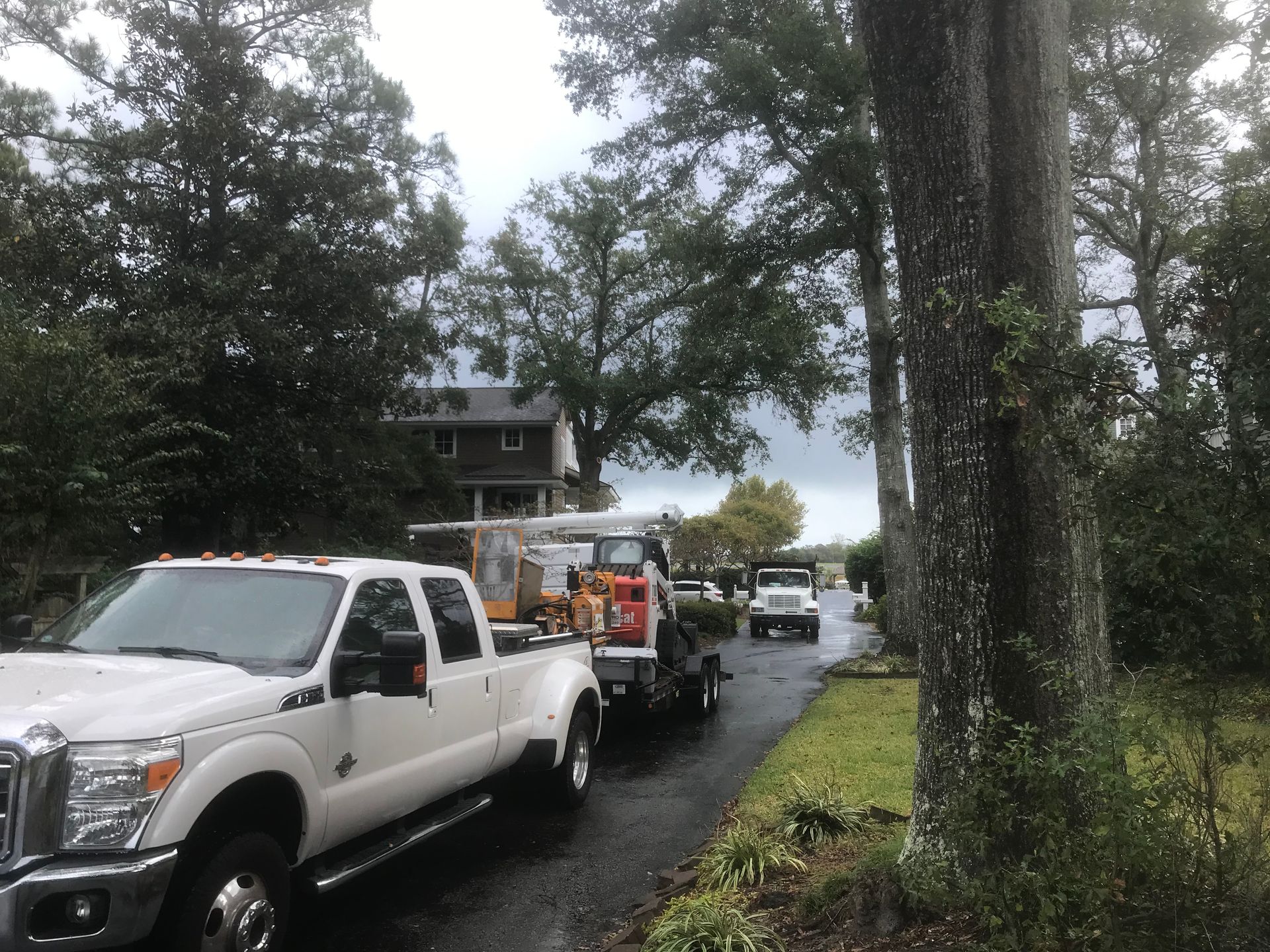A white truck is parked on the side of the road