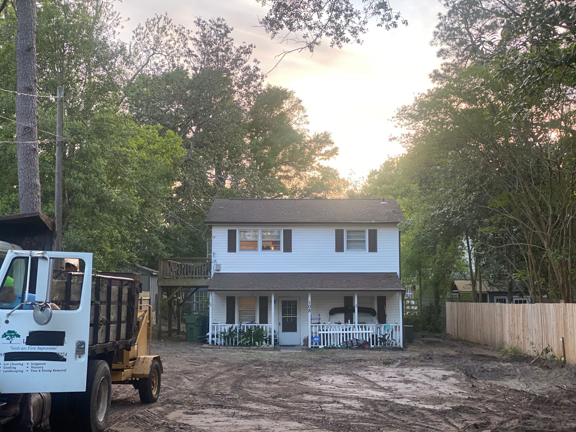 A dump truck is parked in front of a house.
