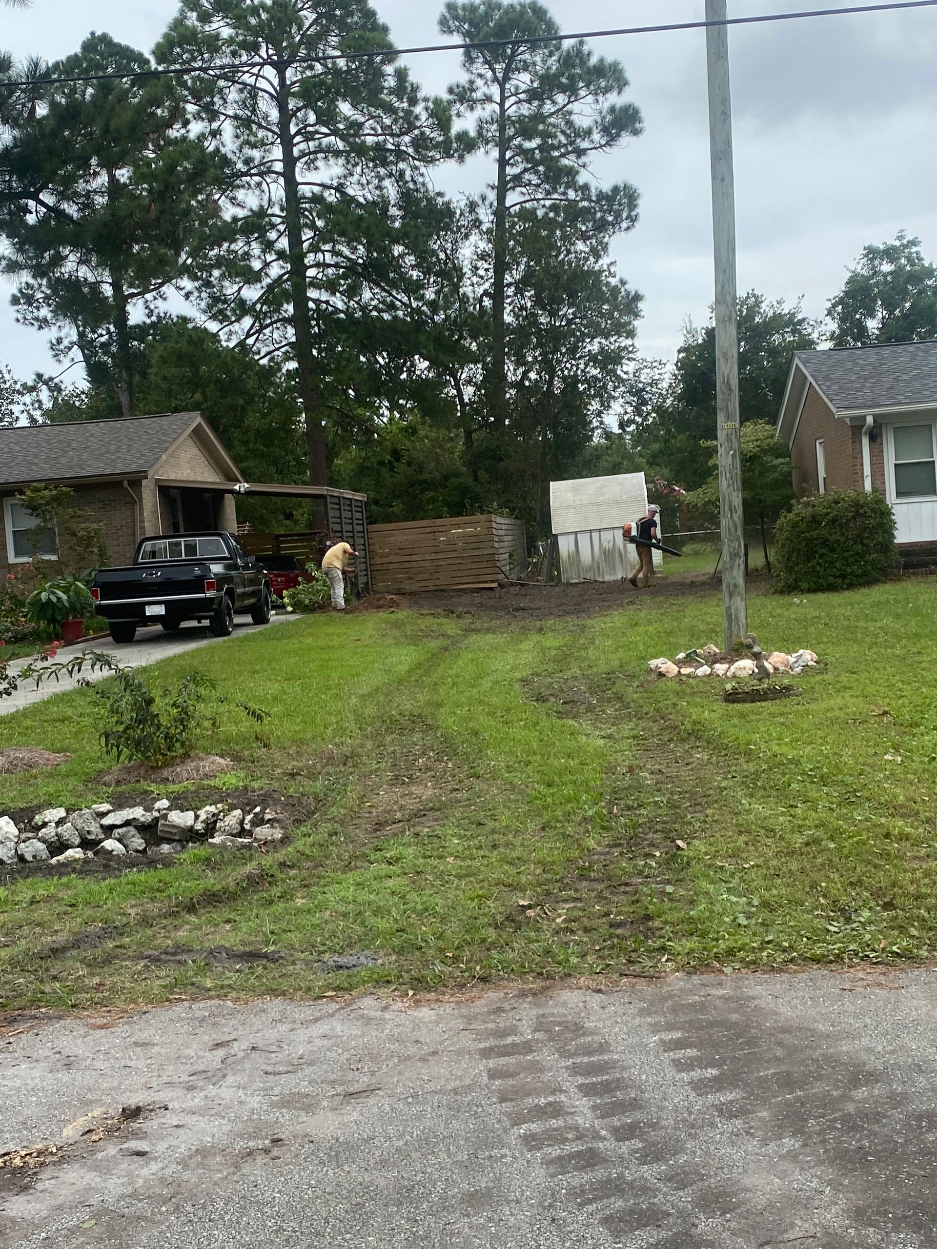 A black truck is parked in front of a house