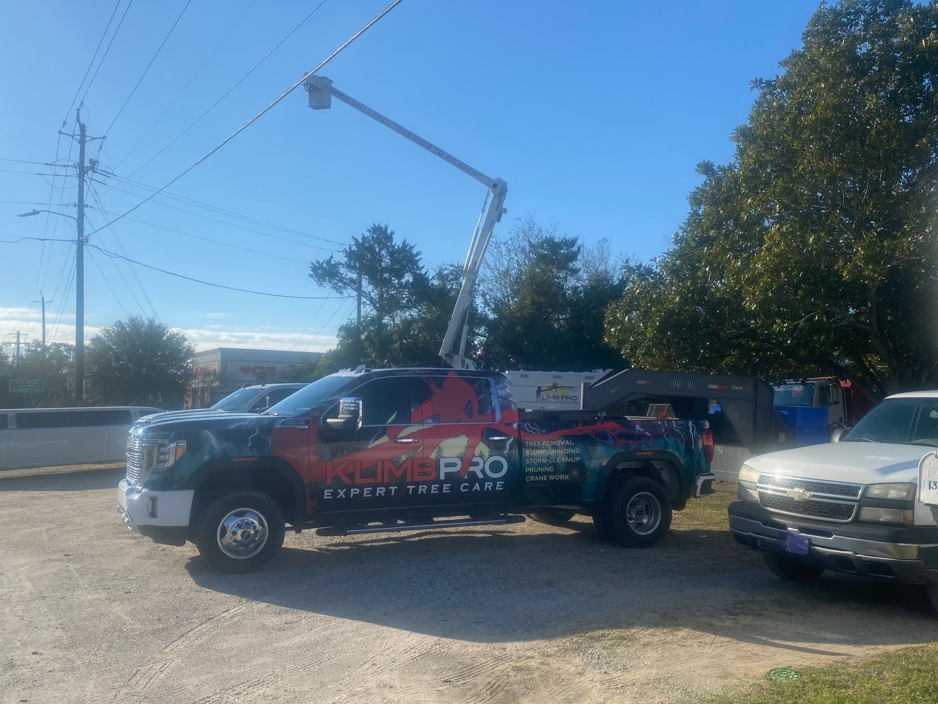 A truck with a crane on top of it is parked in a parking lot.