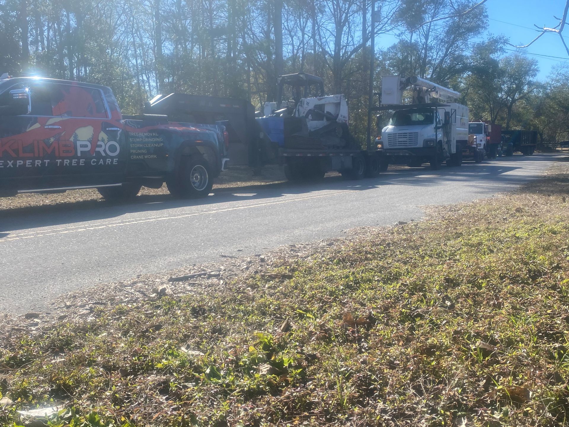 A row of trucks are parked on the side of a road.