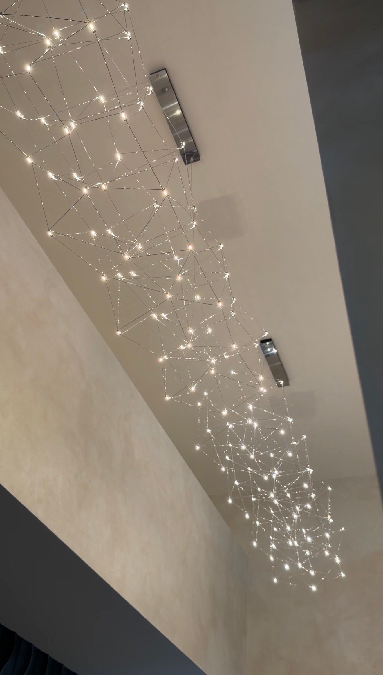 Ceiling with sparkling string lights and recessed fixtures in a modern interior