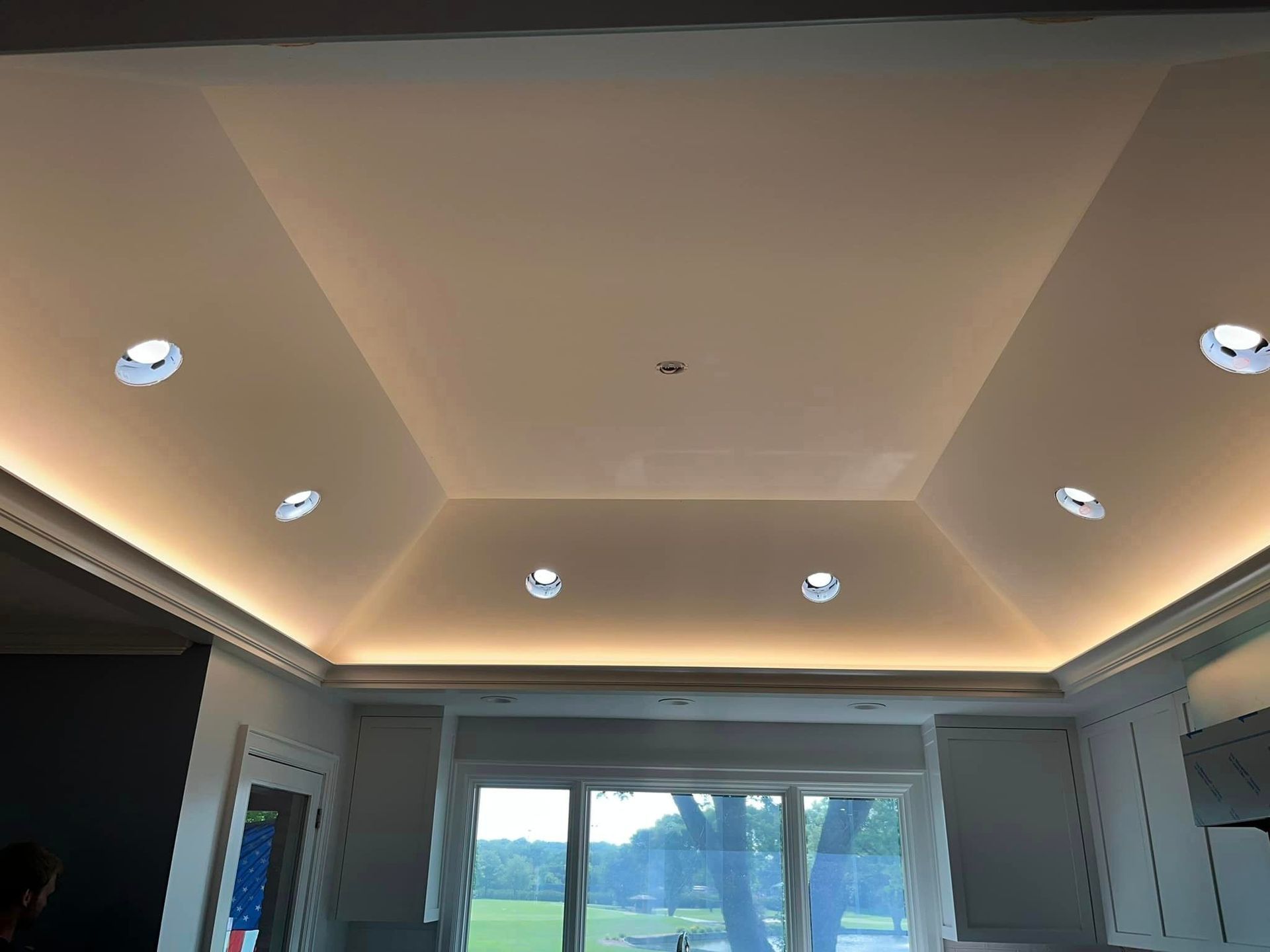 A kitchen with a ceiling that has a lot of lights on it.