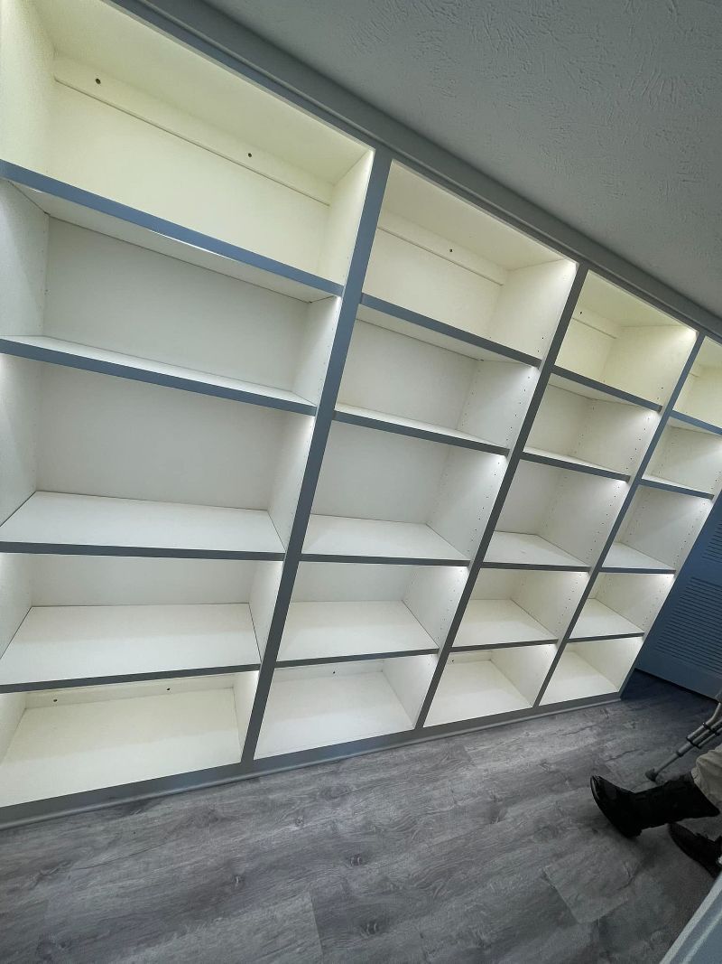 A room with a lot of shelves and lights on them