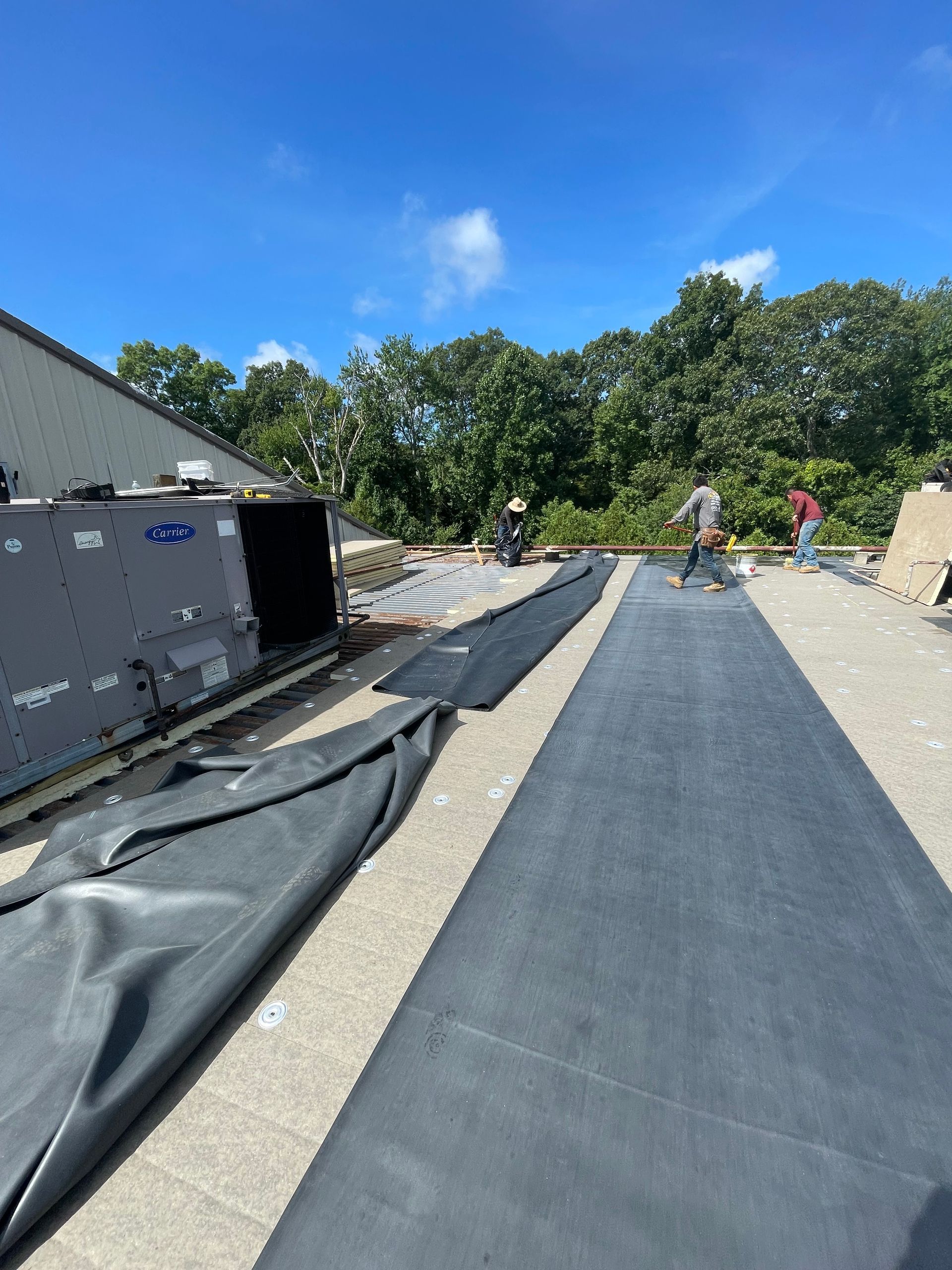 A group of people are working on a roof