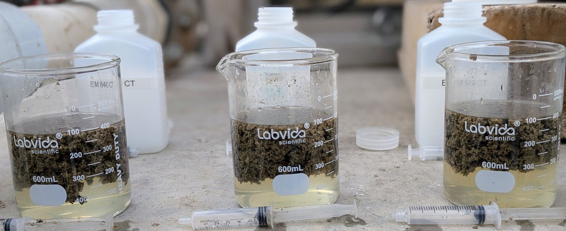 Blue water filtration tanks and pipes in an industrial basement.