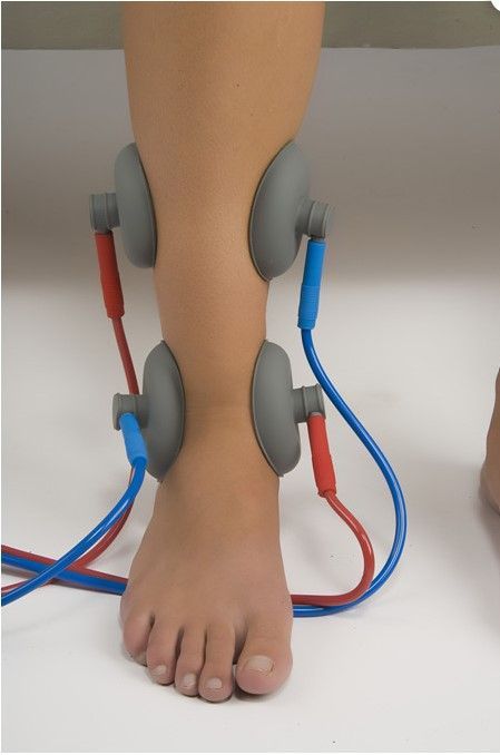 A person 's foot with wires attached to it