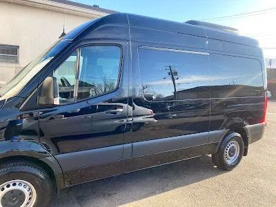 Black cargo van parked outdoors.