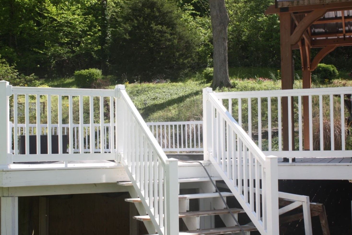 A white deck with stairs leading up to it