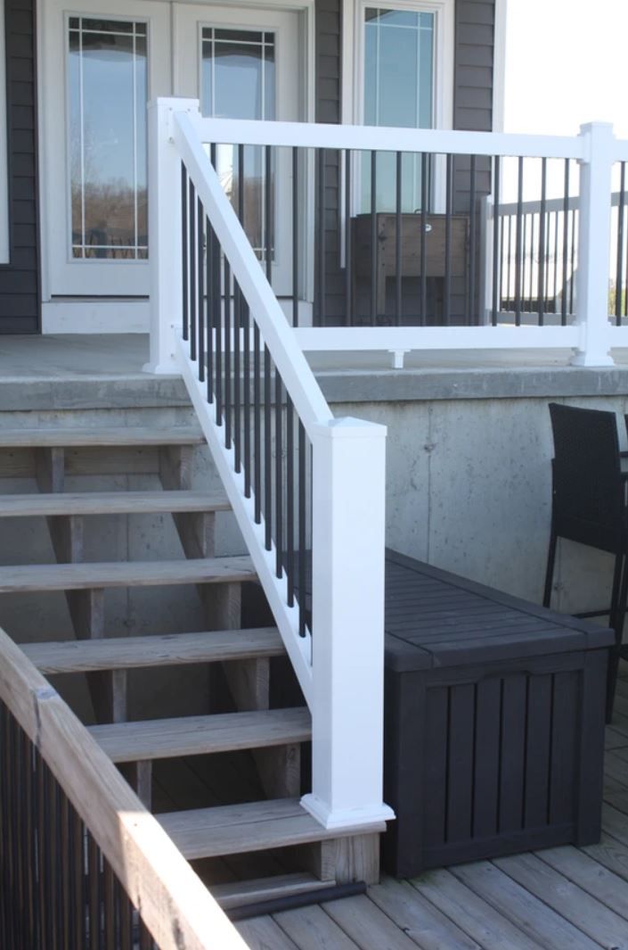 Stairs leading up to a deck with a white railing