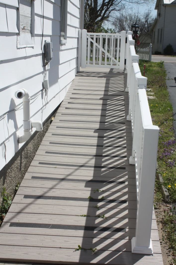 A wooden ramp leading to a white house