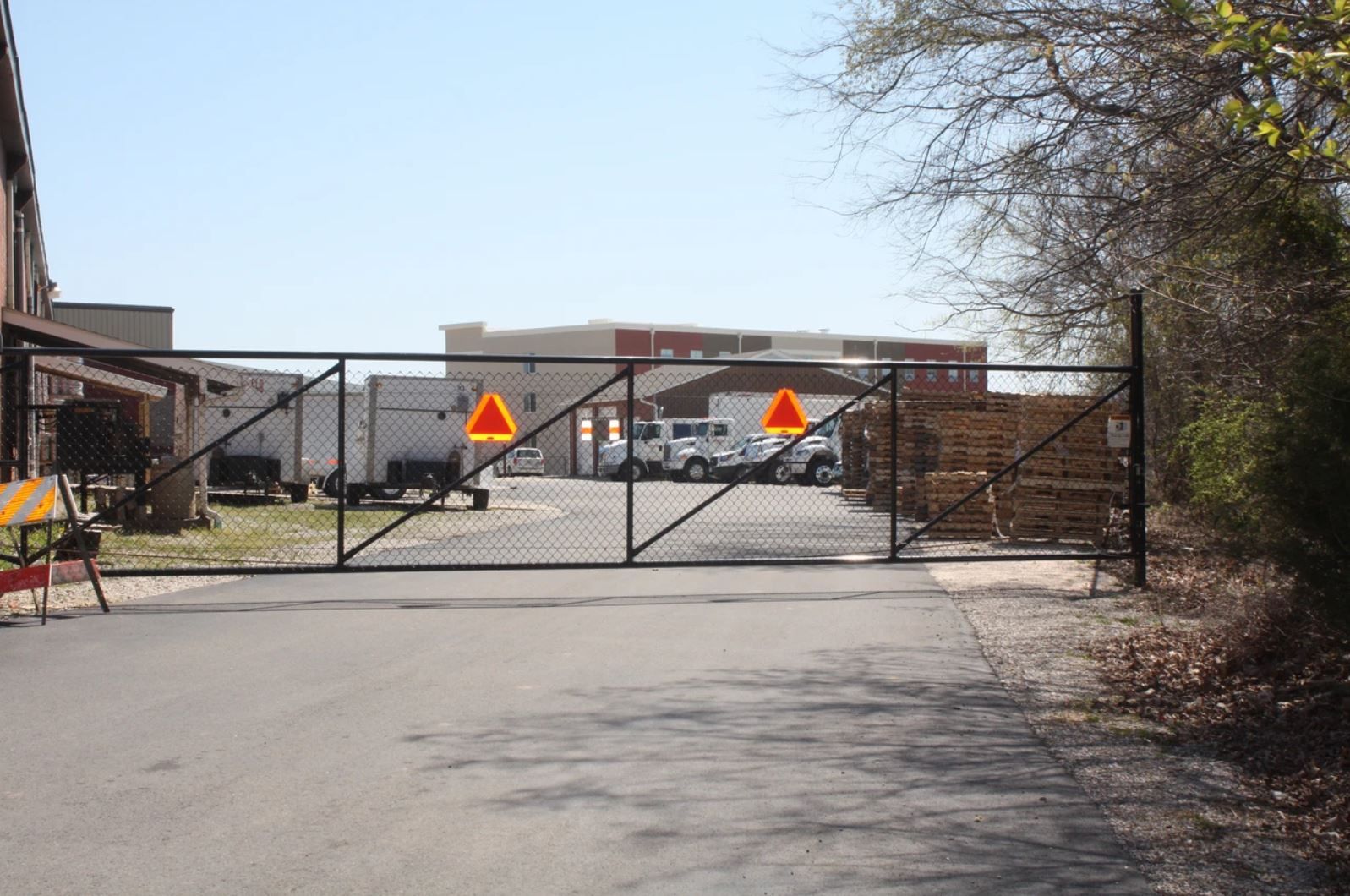 A fence with a triangle on it is blocking the entrance to a building