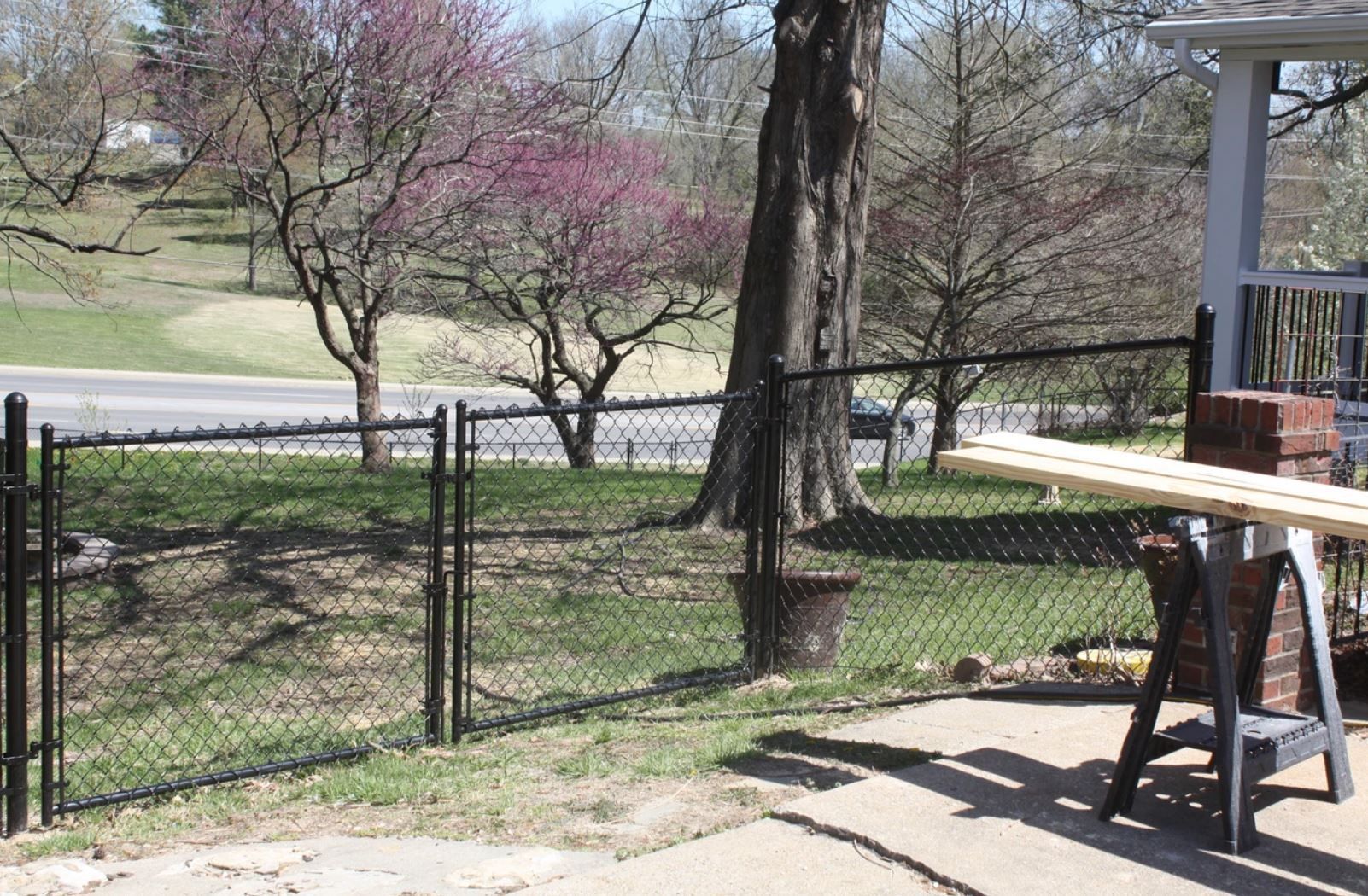 A chain link fence is being built in a backyard