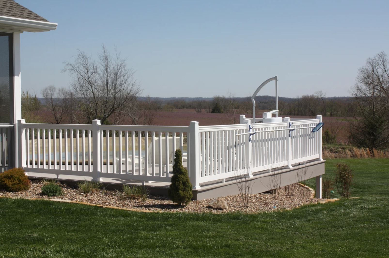 A white deck with a view of a field
