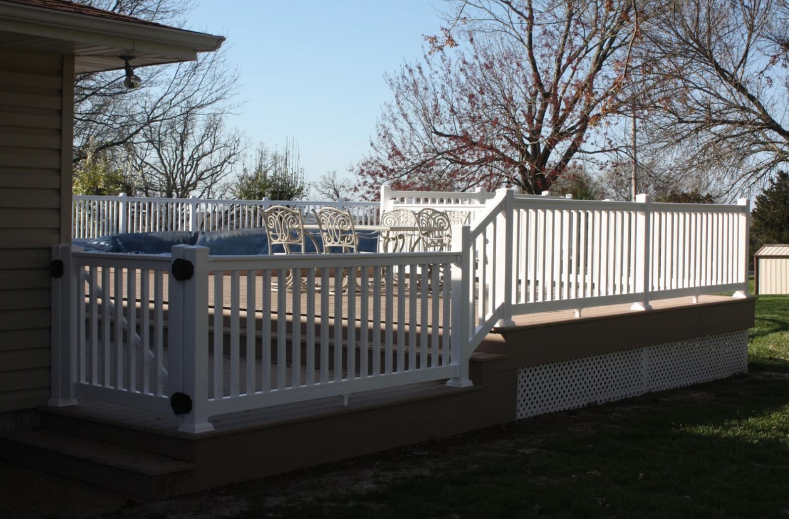 A large white deck with a fence around it