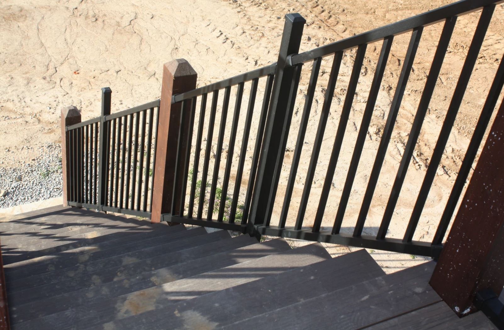 A fence with a wooden post on the side of it