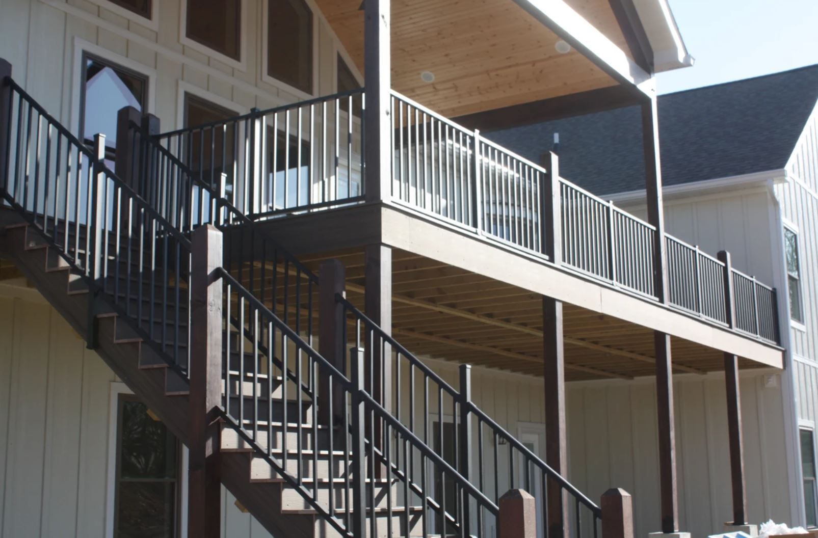A house with a deck and stairs leading up to it