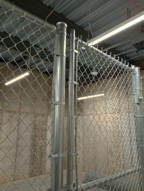 A chain link fence with a gate in a room