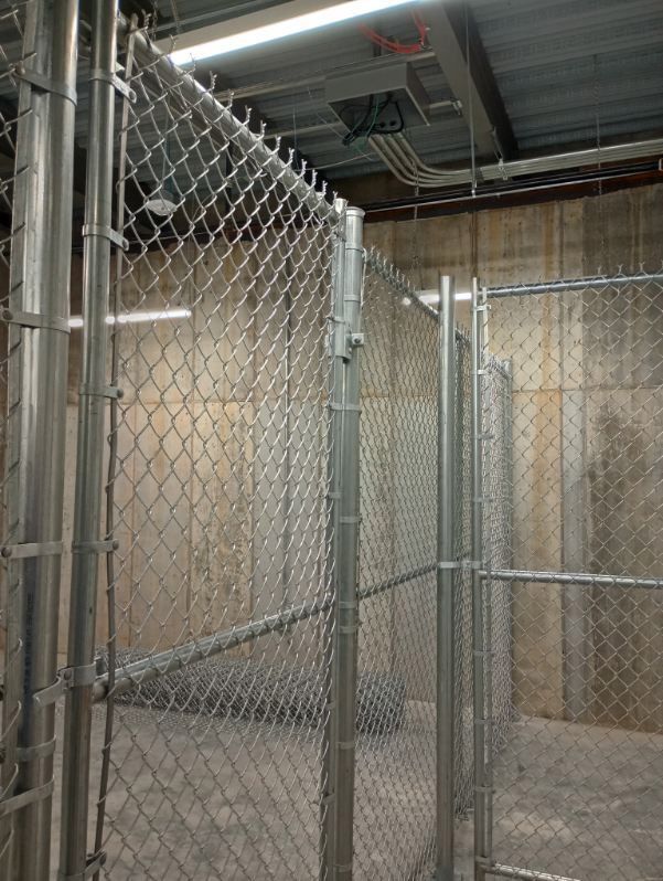 A chain link fence is surrounding a room