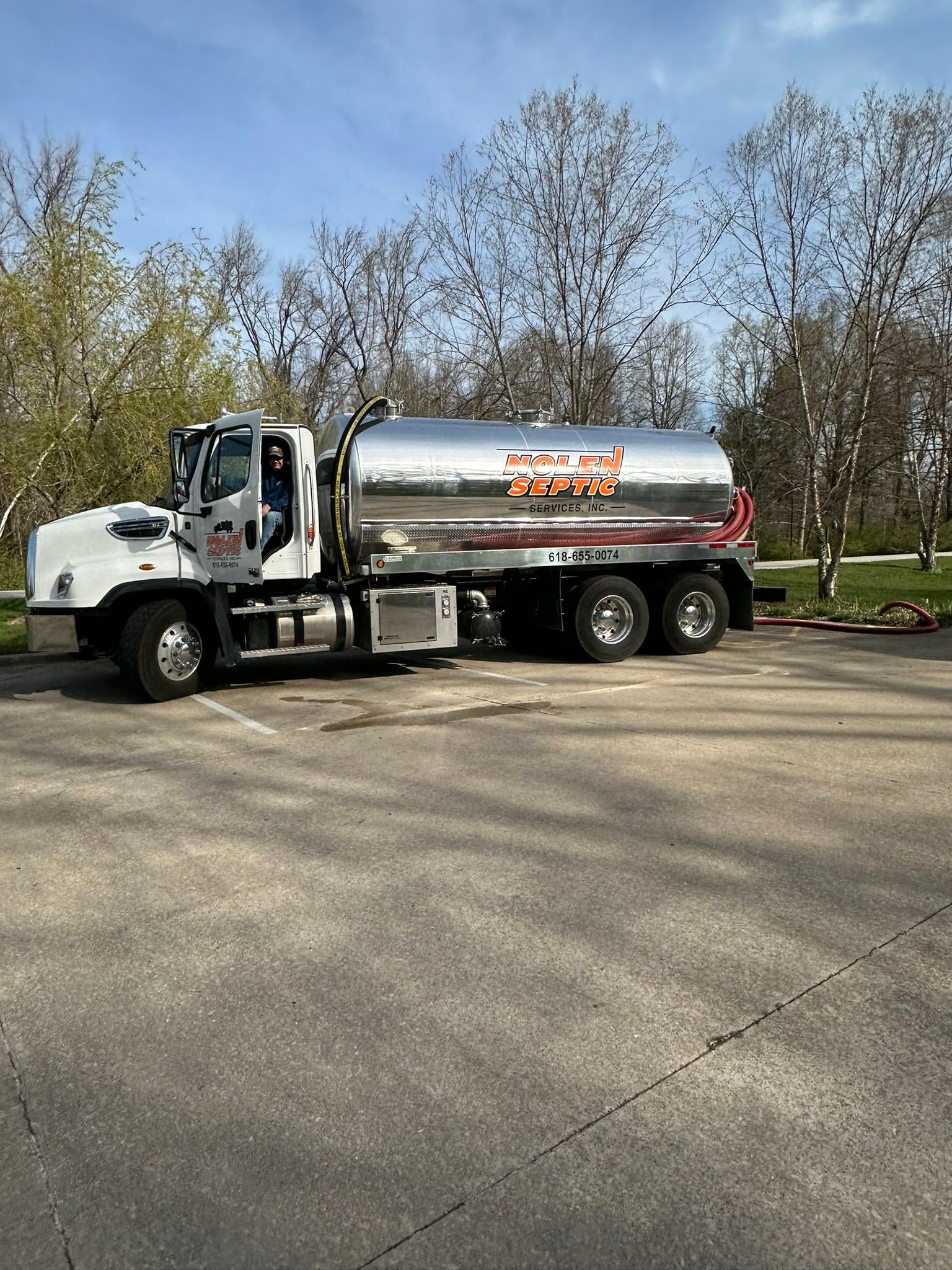 A tanker truck is parked in a parking lot.