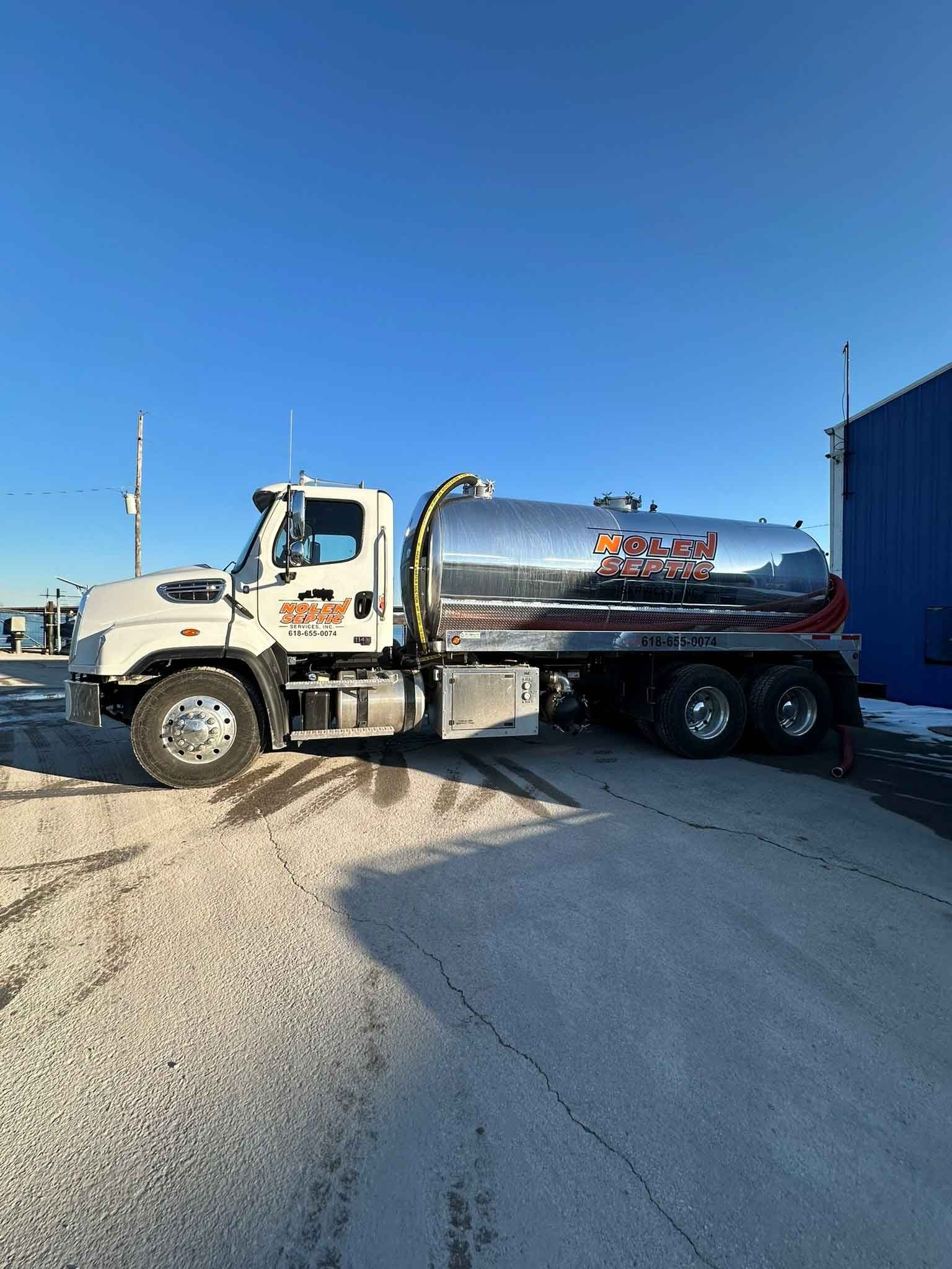 A large tanker truck is parked in a parking lot.