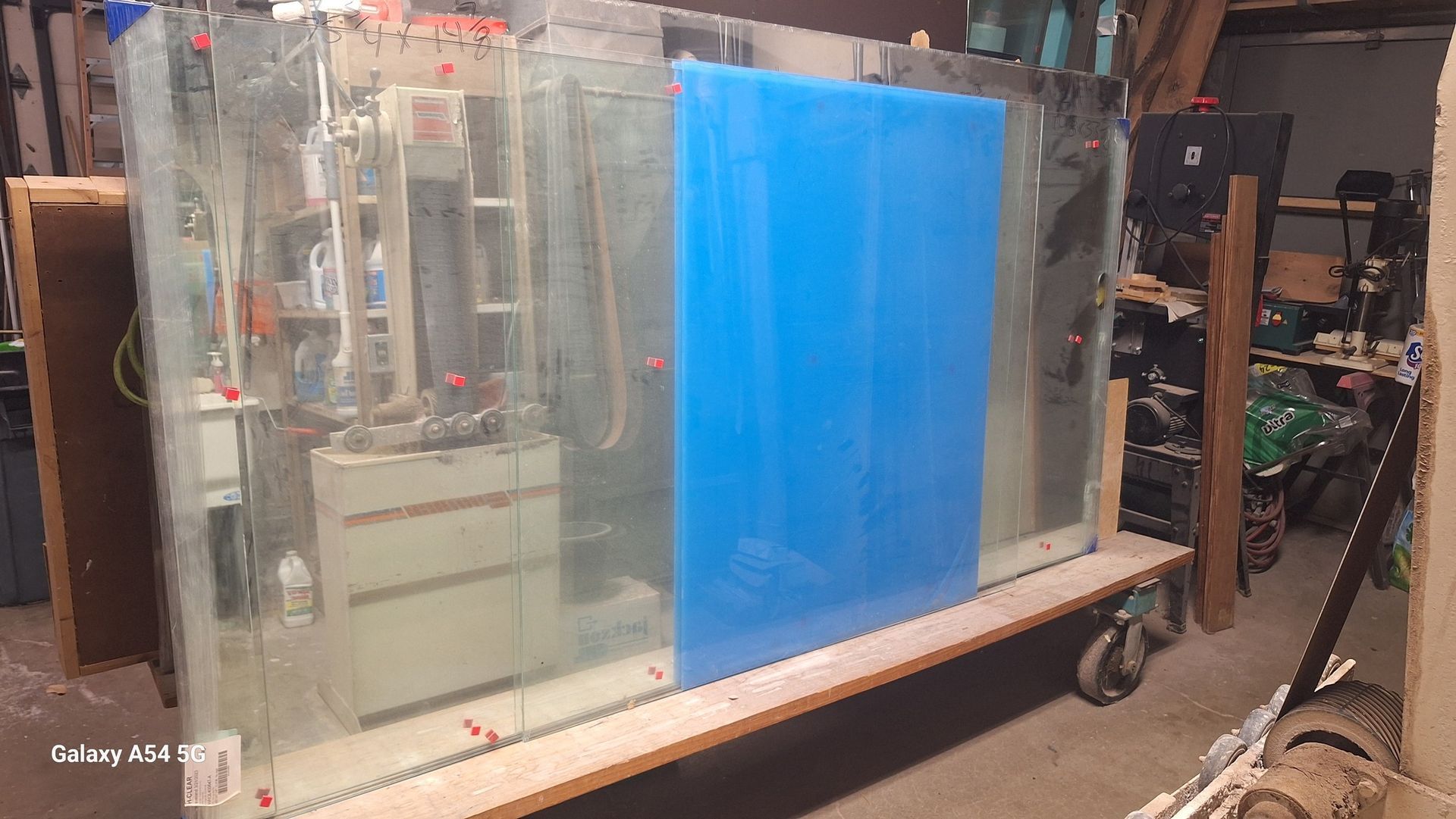 A large glass aquarium is sitting on top of a wooden table.