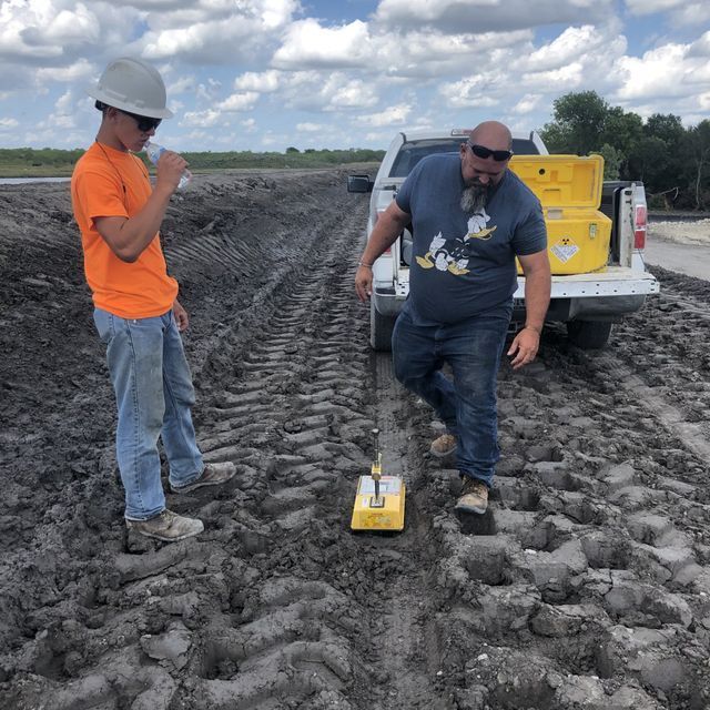 a man in an orange shirt is standing next to a man in a blue shirt with mickey mouse on it