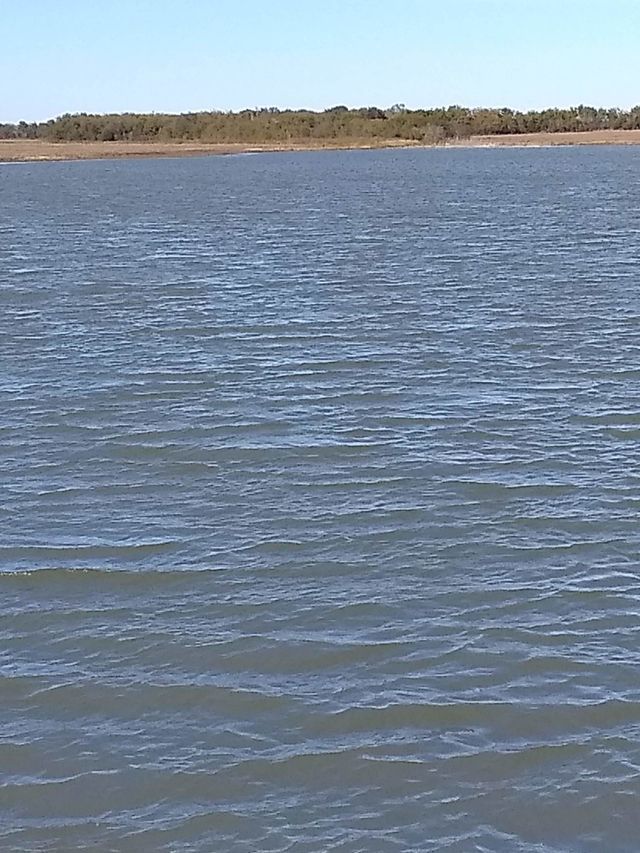a large body of water with a small island in the distance