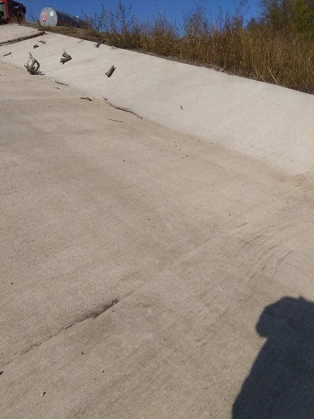 a shadow of a person is cast on a concrete surface