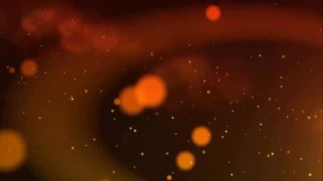 Abstract orange and gold bokeh lights on a dark background